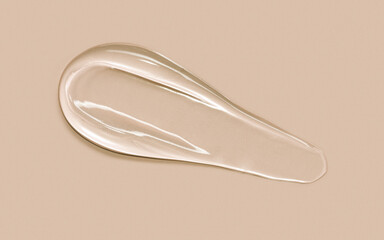 Clear cosmetic gel serum oil texture isolated on beige background. Hyaluronic acid skincare moisturizer product