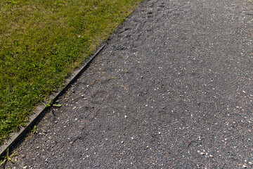 Obraz premium part of a walkway sprinkled with small rubble and stonesecological-style park path for walking