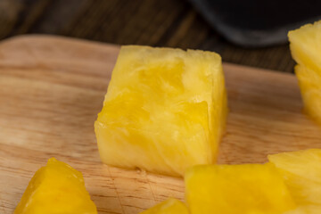 ripe pineapple of yellow-orange color cut into pieces