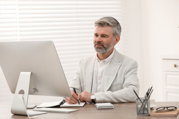 Fototapeta premium Professional accountant working at wooden desk in office