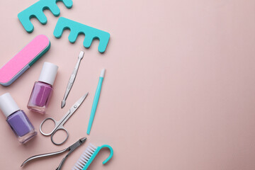Set of pedicure tools on pink background, flat lay. Space for text