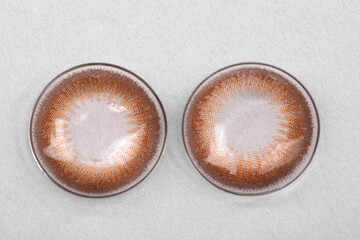 Two color contact lenses on white background, top view
