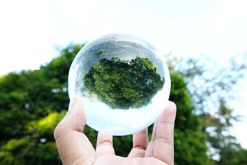 Glass ball display waterfall at the forrest.The concept of environment, nature protection, ecology,