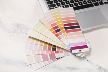 Many color palettes and laptop on light background