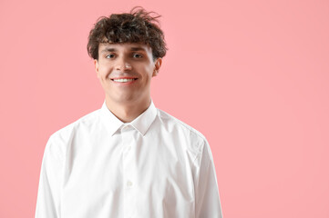 Portrait of handsome young man on pink background