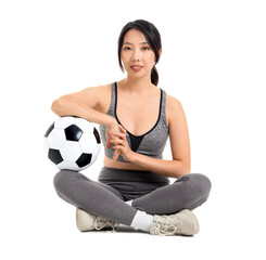 Happy young sporty Asian woman with soccer ball sitting on white background