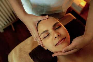Closeup caucasian woman enjoying relaxing anti-stress head massage and pampering facial beauty skin...
