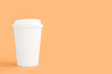 White takeaway paper cup on beige background