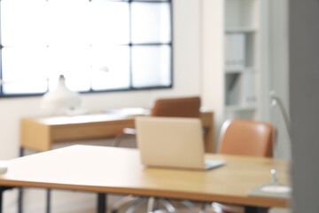 Blurred view of stylish office with workplaces