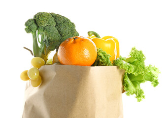 Paper bag with fruits and vegetables on white background. Grocery shopping