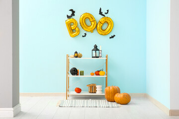 Interior of living room decorated for Halloween with balloons and shelf unit
