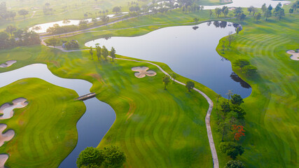 Golf course sport Aerial top view, golf field landscape with sunrise view in the morning shot. Bangkok Thailand, Golf course in fairway and putting green, sunny sky