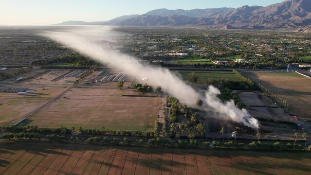 Plume of smoke travels across the Coachella Valley to the Salton Sea as a pile of mulch burns in the Empire Polo Fields