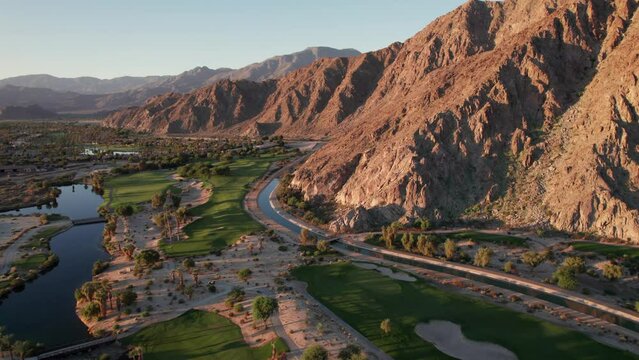 Sunrise aerial view of La Quinta mountains, surrounded by golf courses and resort communities