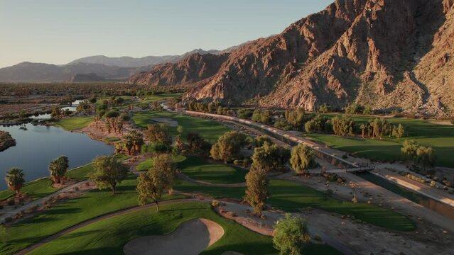 Sunrise aerial view of La Quinta mountains, surrounded by golf courses and resort communities