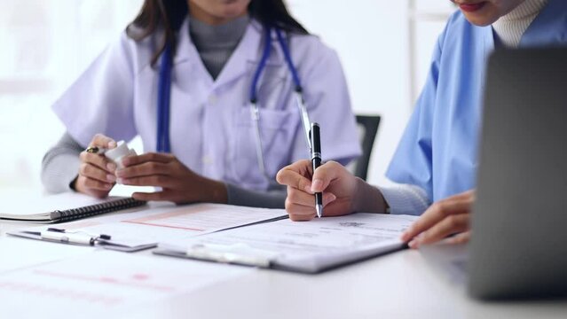 Female doctor is in a meeting to discuss the analysis of documents from trials on the efficacy of a new drug.