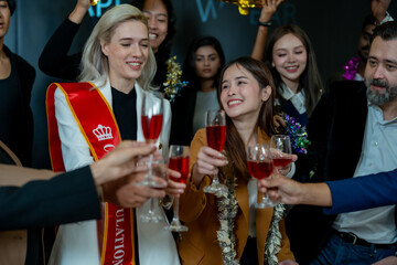 Group of office workers celebrate Christmas and New Year by dancing and drinking wine. Group of international friends and boss dancing with employees.