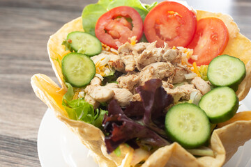 A view of a chicken salad taco bowl.