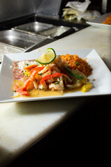 A view of a plate of seared shrimp in butter sauce.
