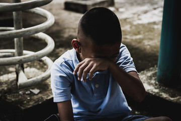 Crying boy student making a stop gesture to plead for an end to child violence stop violating...