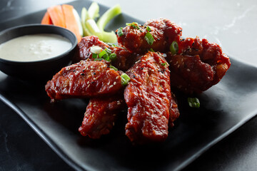 A view of a plate of Asian glaze chicken wings.