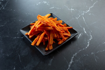 A view of a plate of sweet potato fries.