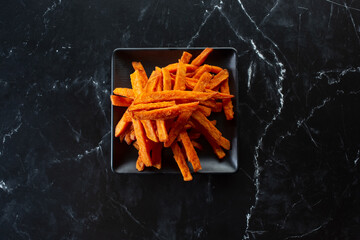 A top down view of a plate of sweet potato fries.