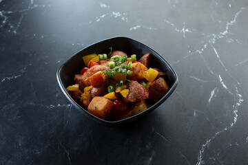 A view of a bowl of roasted potatoes.