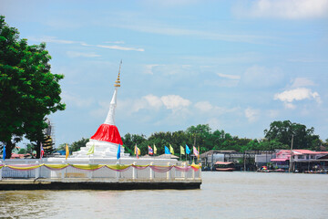 White tilt Mon pagoda beside the Chao Phraya River at Wat Poramai Yikawat Worawihan, Koh Kret, Nonthaburi.