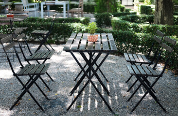 Fototapeta na wymiar Vintage coffee tables and chairs is for outdoor in garden. Coffee table for furniture at cafe.