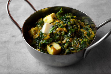 A view of a bowl of saag paneer.