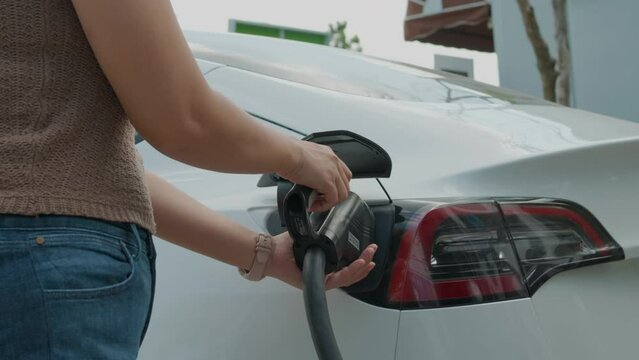 Business woman use EV ccs type2 charge electric car in station ecology transport concept
