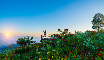 Female tourist taking photos at Doi Luang Chiang Dao viewpoint, Thailand.
