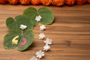 Obraz na płótnie Canvas Maa Lakshmi or Godess footprint painted on apta leave. Hindu festival dasara dushera celebration. with marogold flowers. 
