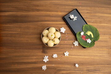 Indian festival dussehra , green leaf, rice and flowers and mobile festive offer concept