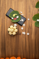 Indian festival dussehra , green leaf, rice and flowers and mobile festive offer concept