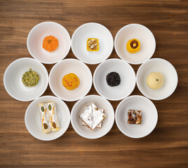 Rangoli of Assorted Indian sweets or mithai in bowl for Diwali or any other festivals.