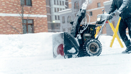 manual snow plow removes snow in the yard