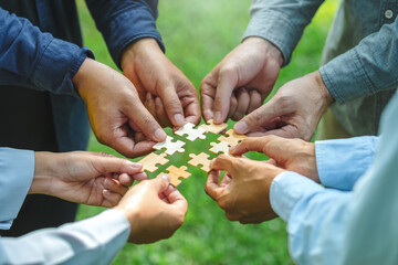World environment day  and ESG Concept of teamwork and partnership Hands join Jigsaw puzzle pieces...