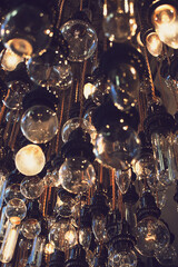 A view of dim retro lightbulb fixtures hanging from rope.