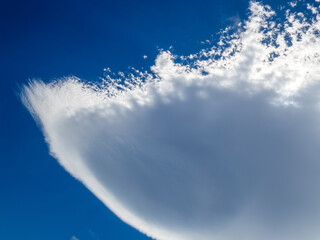 A large lenticular cloud shaped like an upside-down jellyfish formed in the sky over the lee of...