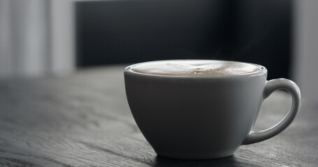white cup with cappuccino with copy space