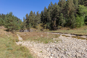 walking along the bed of a mountain river with a visit to unknown places