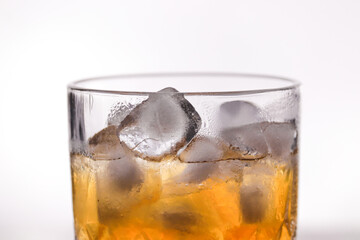 whiskey in a glass filled with ice cubes