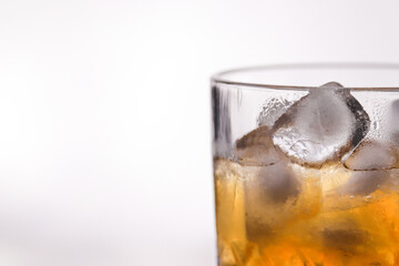 whiskey in a glass filled with ice cubes