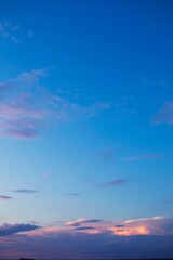 Beautiful blue sky with dark clouds. Sunset, evening, dramatic sky. Cumulus and cirrus clouds.