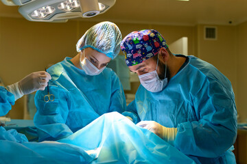 a surgeon performs an operation with a hospital