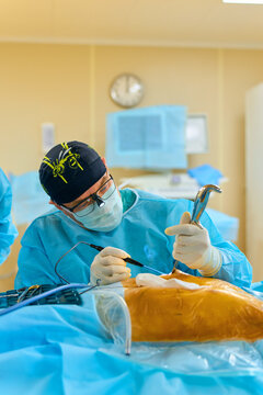 a surgeon performs an operation with a hospital
