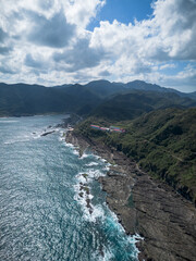 Fototapeta premium Aerial view of Bitoujiao lighthouse, a famous scenery of Taiwan northeast corner. Birds eye view in Bitoujiao cape, Ruifang district, New Taipei, Taiwan.