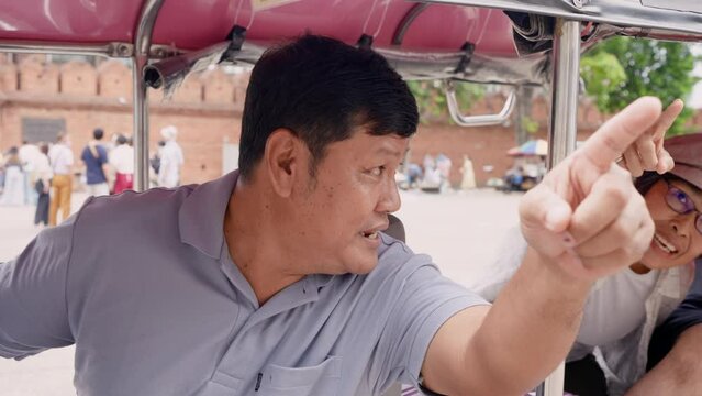 Close-up tuk tuk driver face, pointing out popular tourist attractions, which anyone who comes Chiang Mai must come here recommend tourists, It is car that general passengers call for shuttle service.